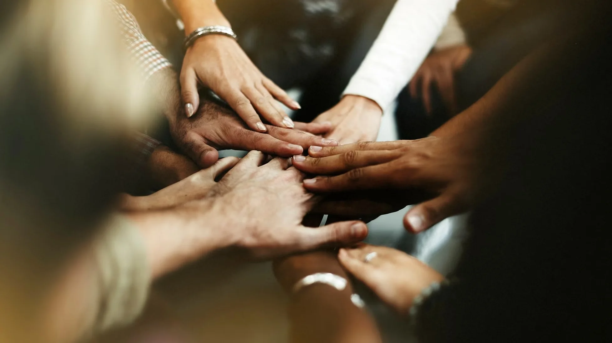 closeup of diverse people joining their hands